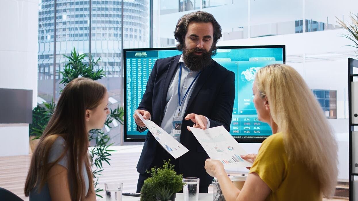 A finance team reviewing invoice and purchase order documents