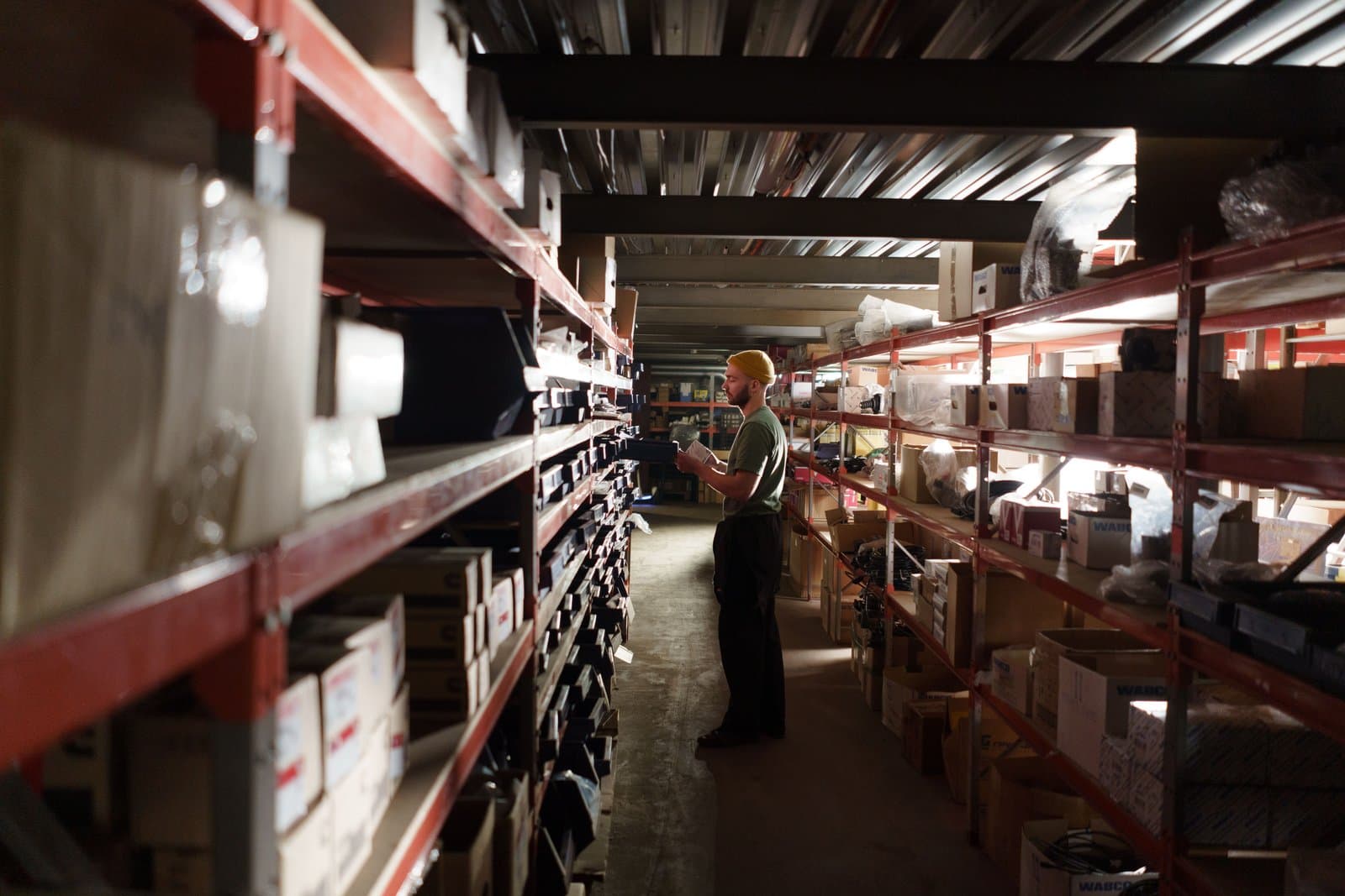 A warehouse operator checking stock against the system of record